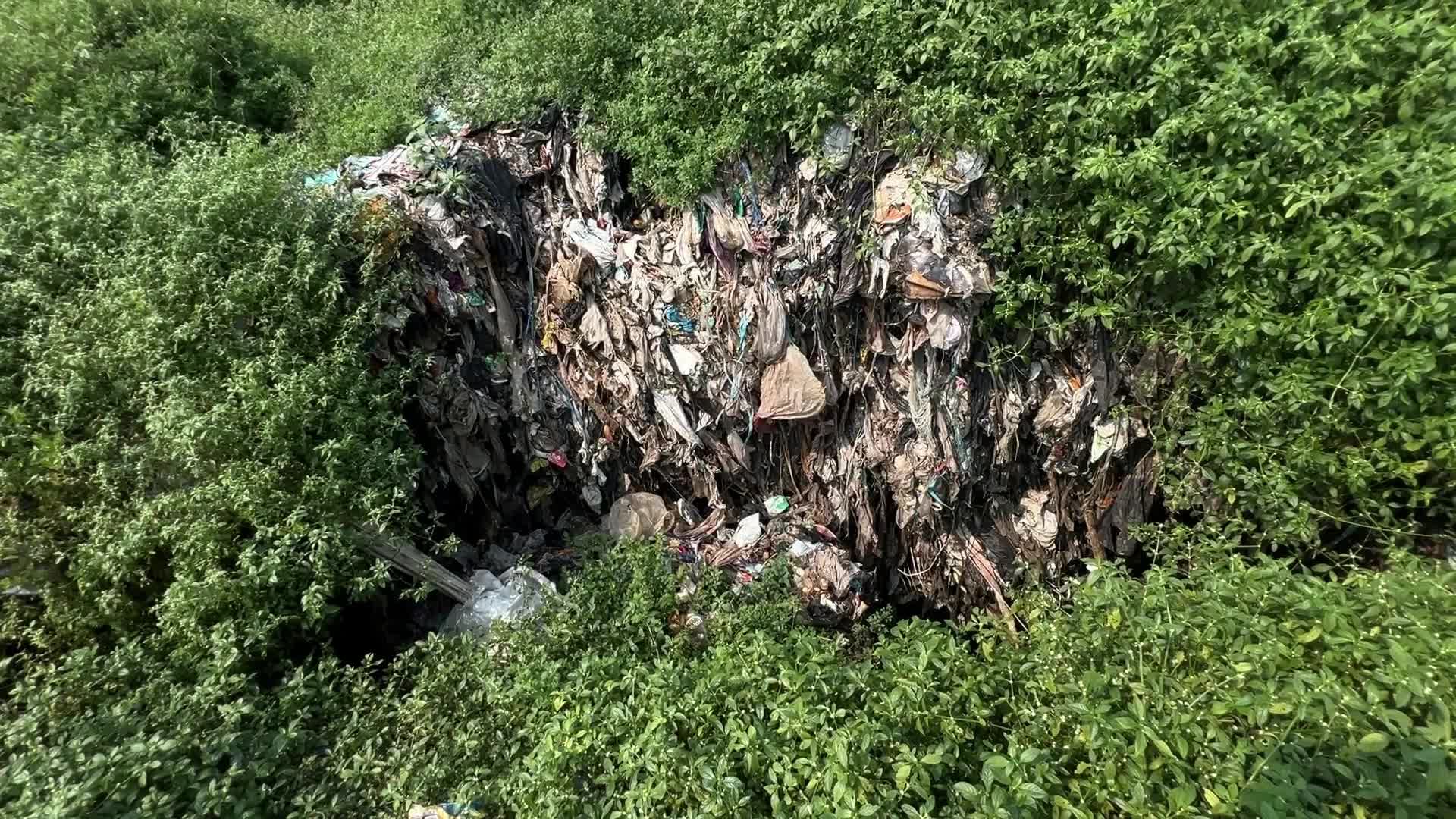 Hill of Garbage waste and poluted river in Indonedia