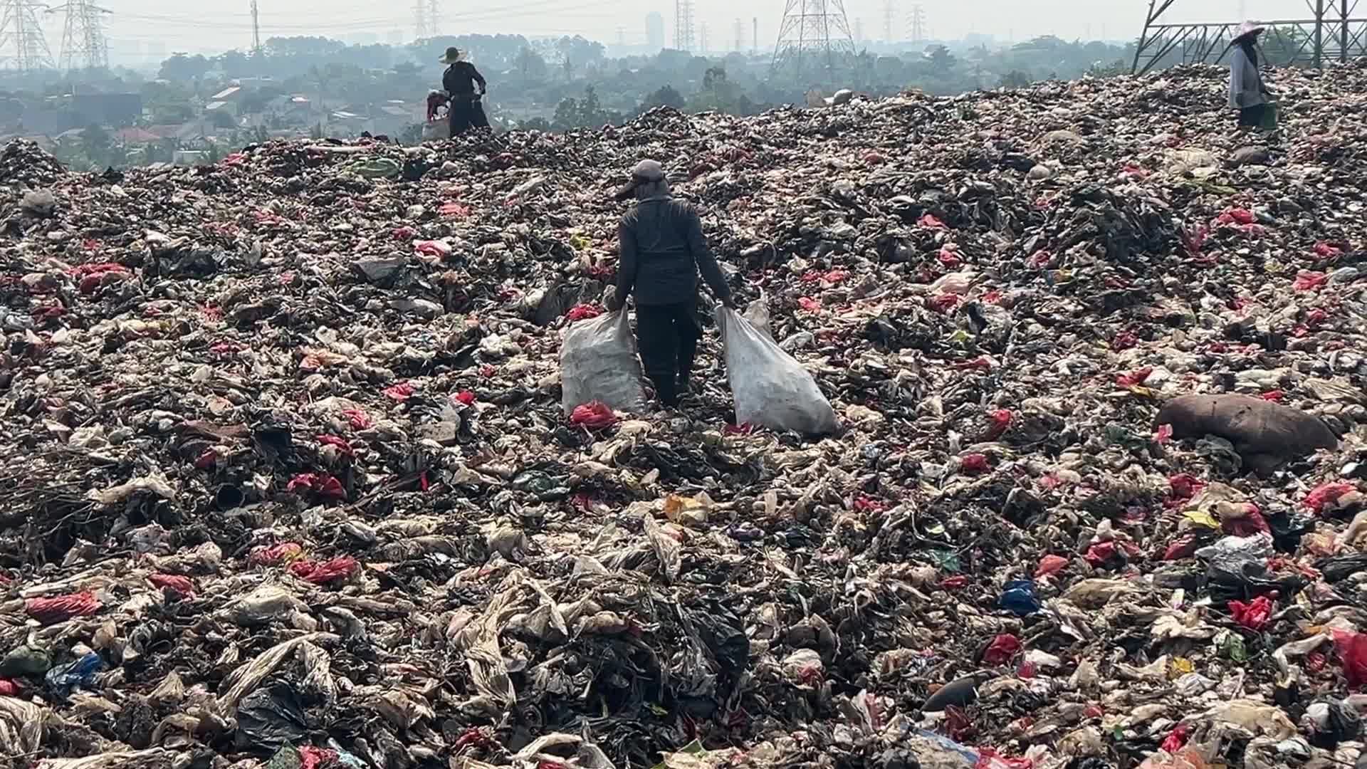 Hill of Garbage waste and poluted river in Indonedia