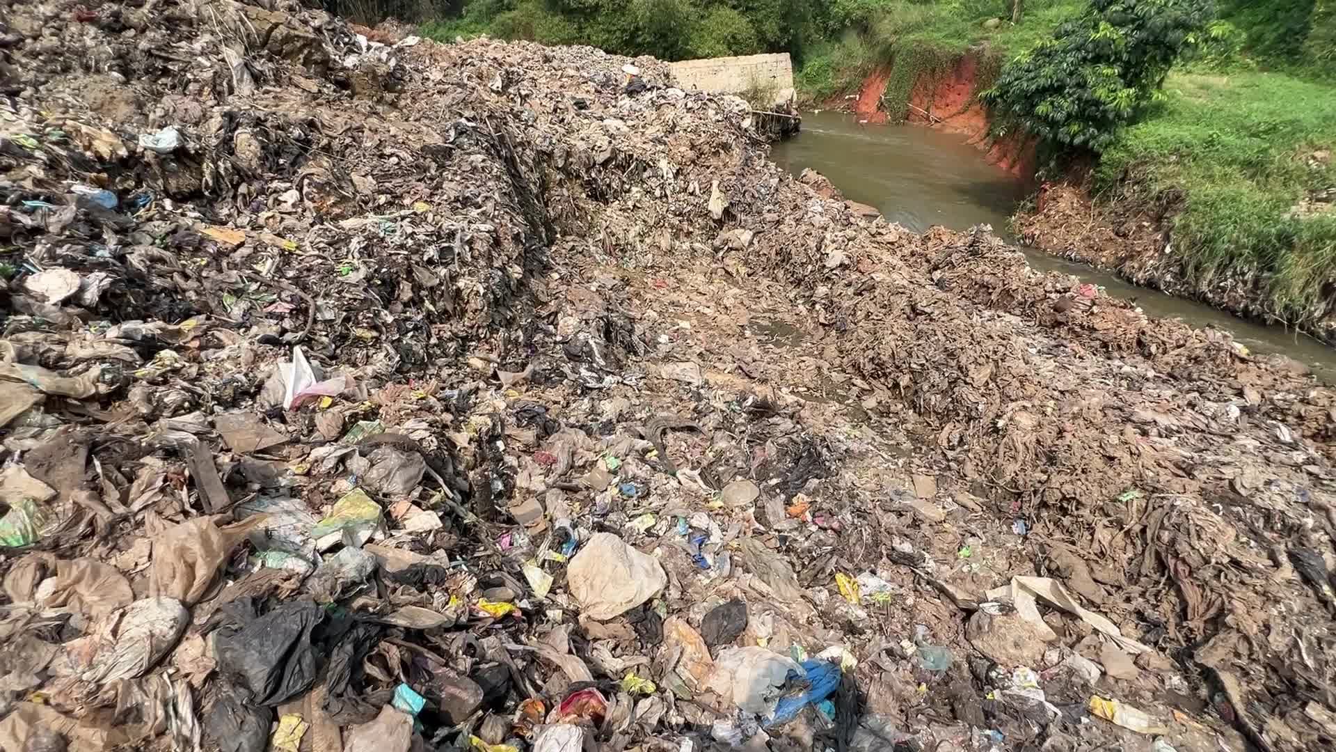 Hill of Garbage waste and poluted river in Indonedia