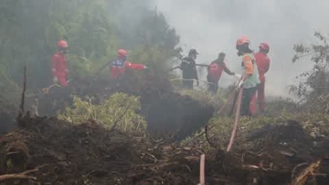 Residents are evacuated due to a forest fire in Riau, Indonesia