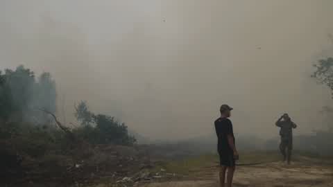Residents are evacuated due to a forest fire in Riau, Indonesia