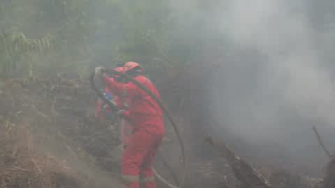 Residents are evacuated due to a forest fire in Riau, Indonesia