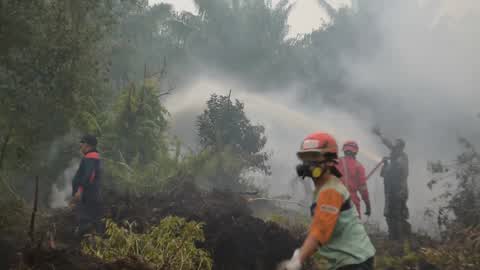 Residents are evacuated due to a forest fire in Riau, Indonesia