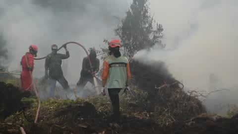 Residents are evacuated due to a forest fire in Riau, Indonesia