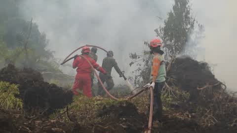 Residents are evacuated due to a forest fire in Riau, Indonesia