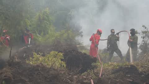 Residents are evacuated due to a forest fire in Riau, Indonesia