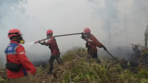 Residents are evacuated due to a forest fire in Riau, Indonesia