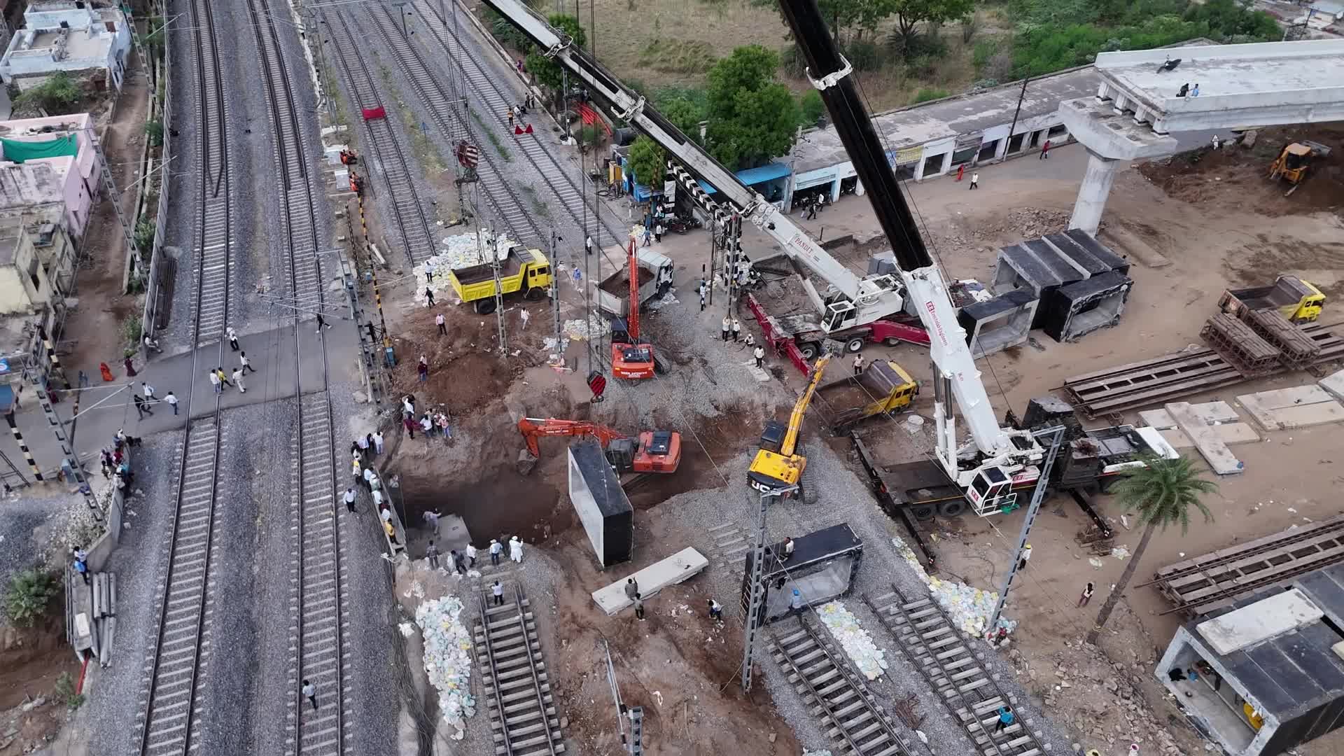 Workers labor at the construction site of a Railway Under bridge in Ajmer