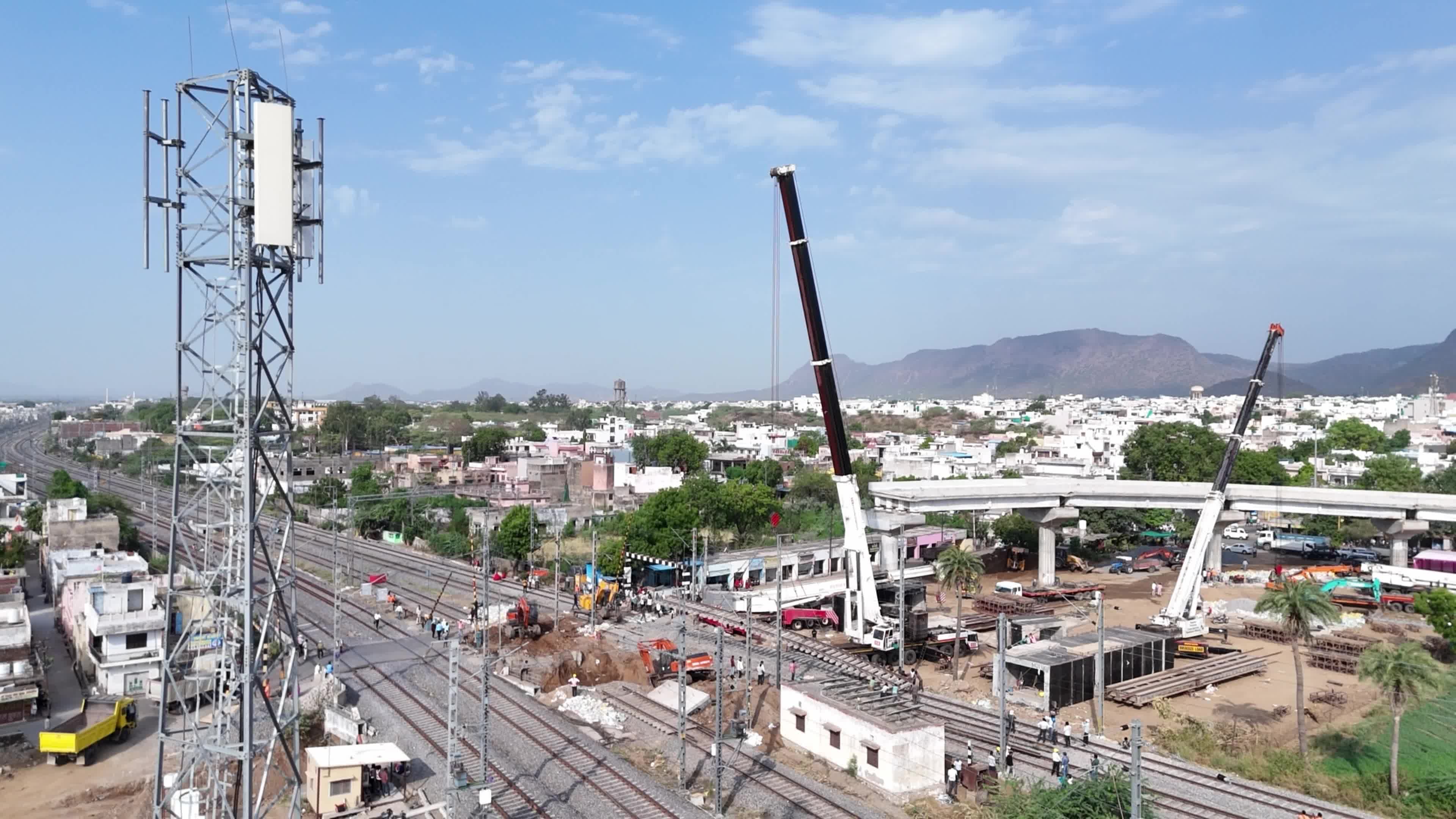 Workers labor at the construction site of a Railway Under bridge in Ajmer