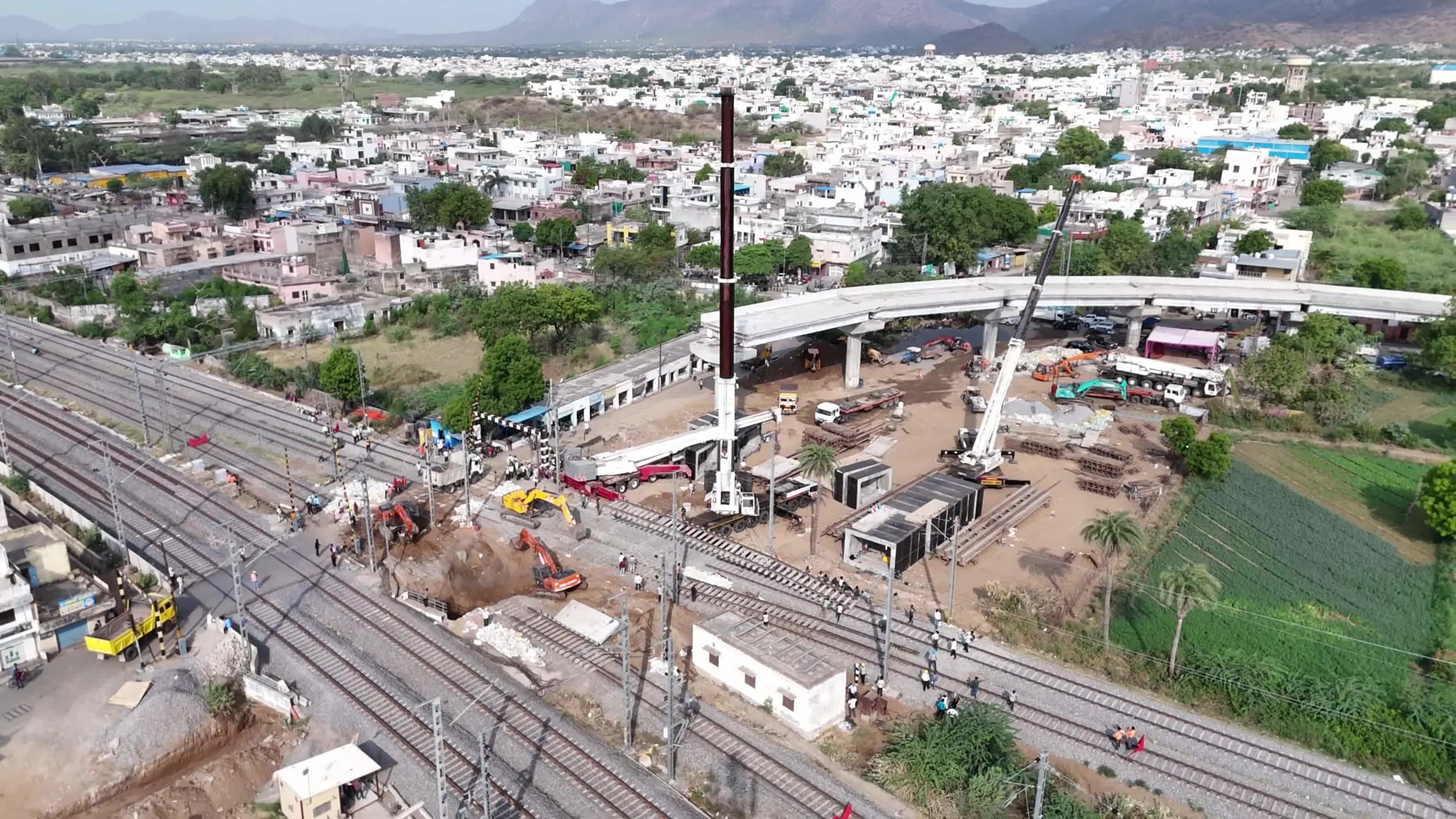 Workers labor at the construction site of a Railway Under bridge in Ajmer