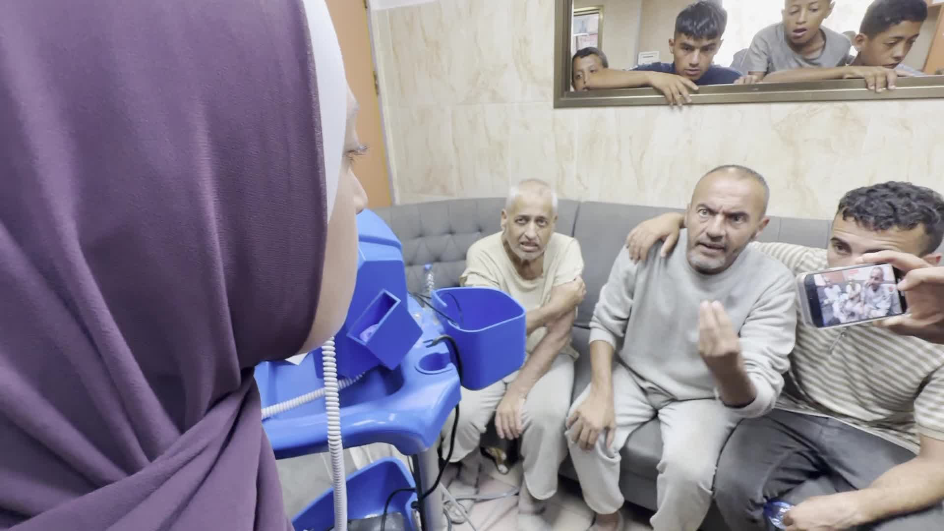 Released Palestinian Man Welcomed by Family at Gaza Hospital Amid Ongoing Conflict