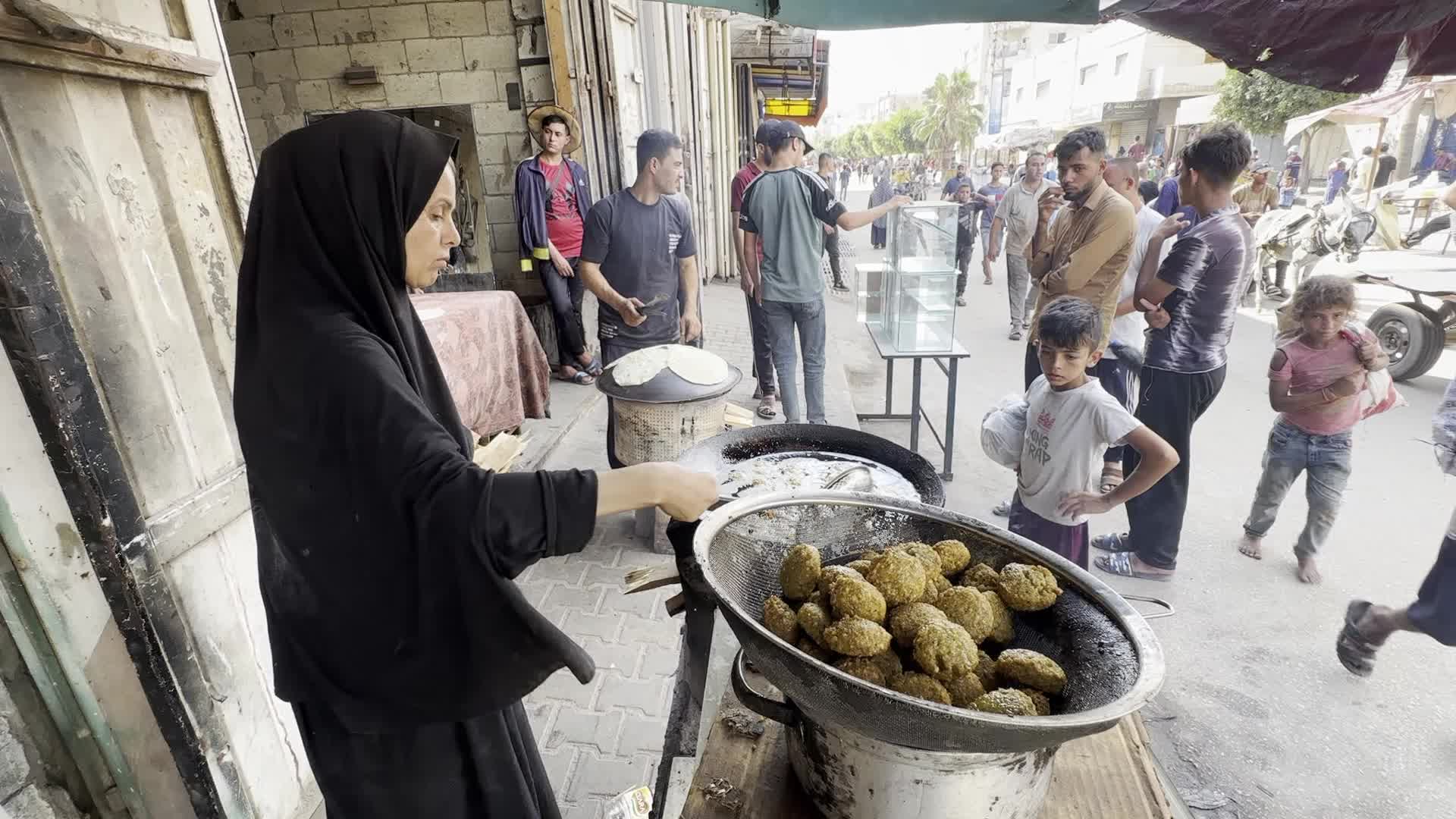 Displaced Palestinian Woman Prepares Flatbread Dough at Stall Kitchen in Central Gaza Strip Amid Ongoing Conflict