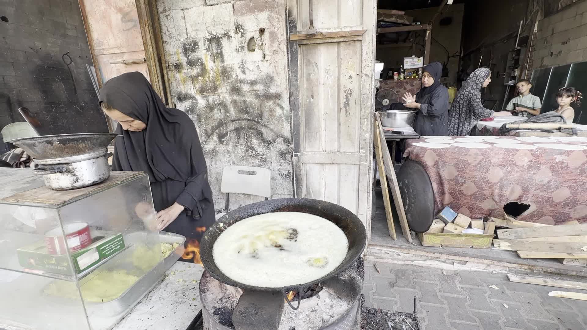 Displaced Palestinian Woman Prepares Flatbread Dough at Stall Kitchen in Central Gaza Strip Amid Ongoing Conflict