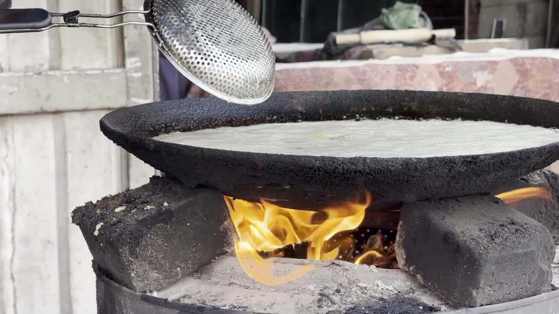 Displaced Palestinian Woman Prepares Flatbread Dough at Stall Kitchen in Central Gaza Strip Amid Ongoing Conflict