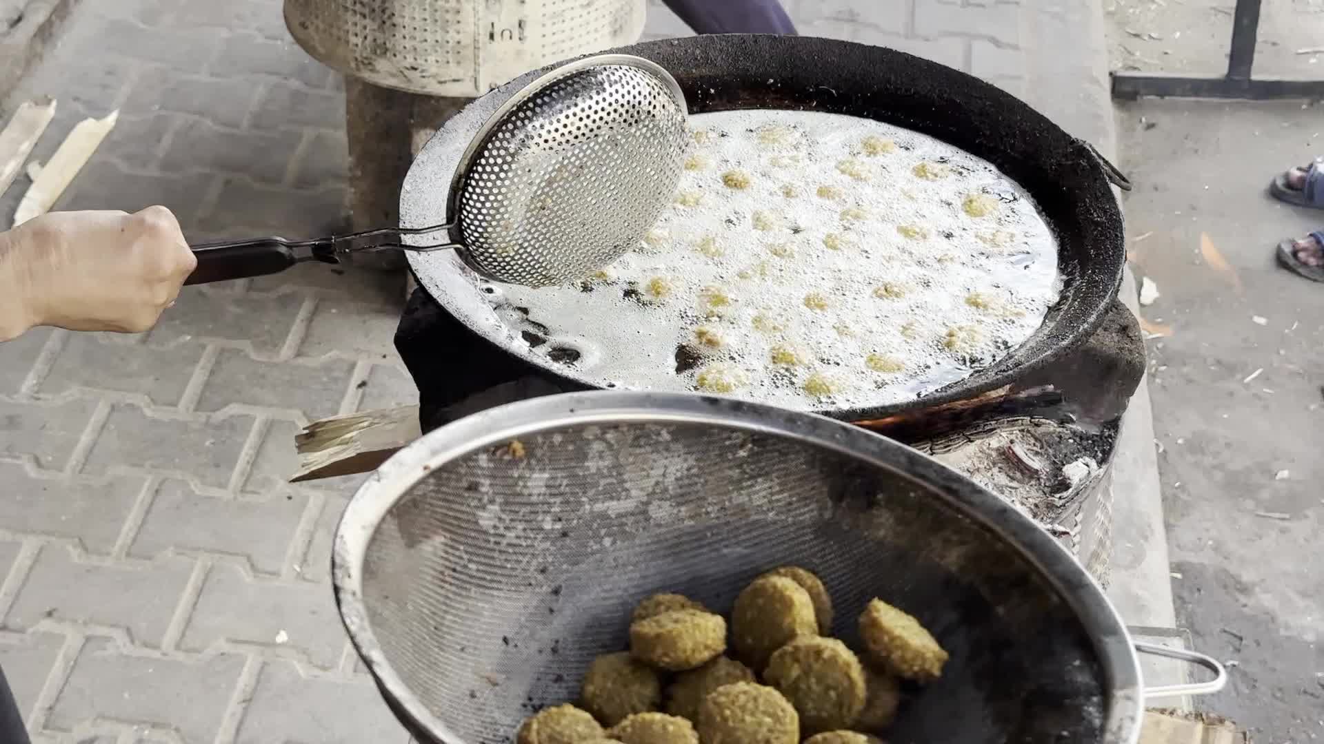 Displaced Palestinian Woman Prepares Flatbread Dough at Stall Kitchen in Central Gaza Strip Amid Ongoing Conflict