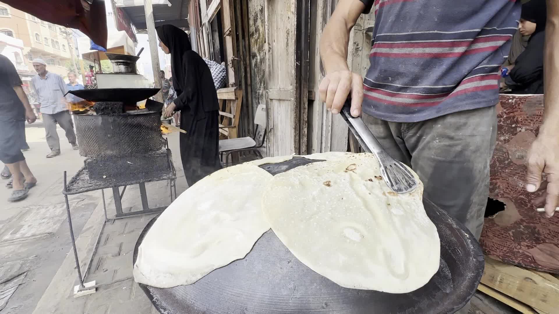 Displaced Palestinian Woman Prepares Flatbread Dough at Stall Kitchen in Central Gaza Strip Amid Ongoing Conflict