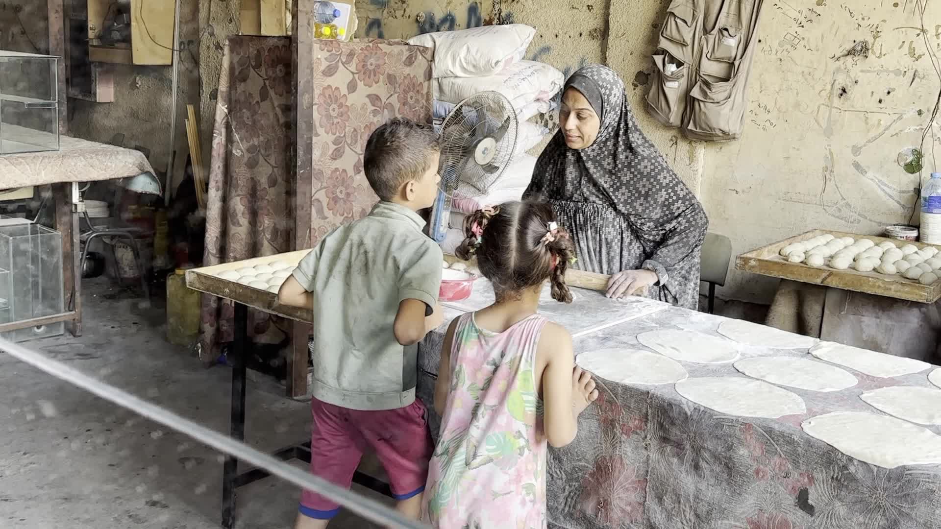 Displaced Palestinian Woman Prepares Flatbread Dough at Stall Kitchen in Central Gaza Strip Amid Ongoing Conflict