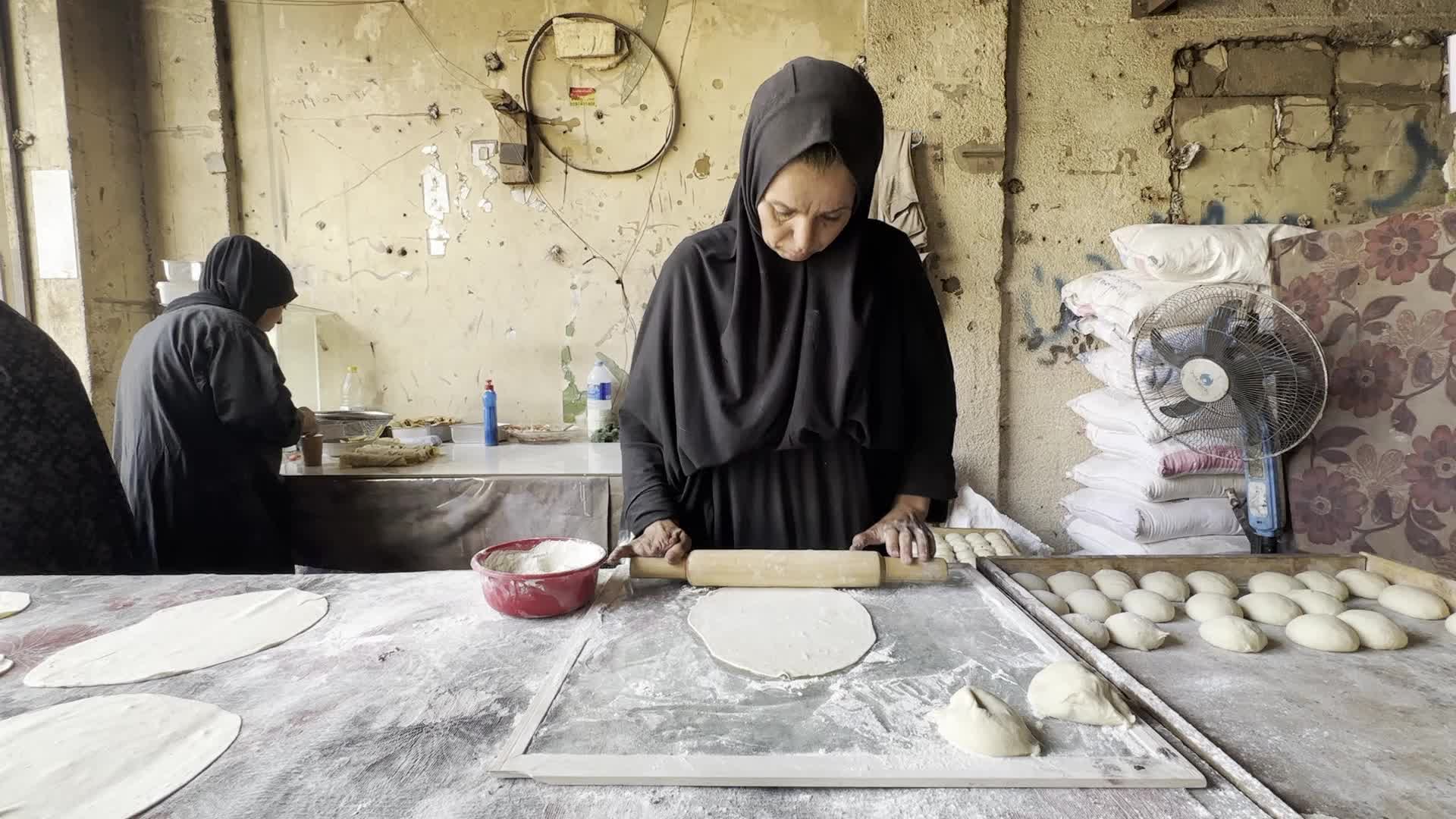 Displaced Palestinian Woman Prepares Flatbread Dough at Stall Kitchen in Central Gaza Strip Amid Ongoing Conflict