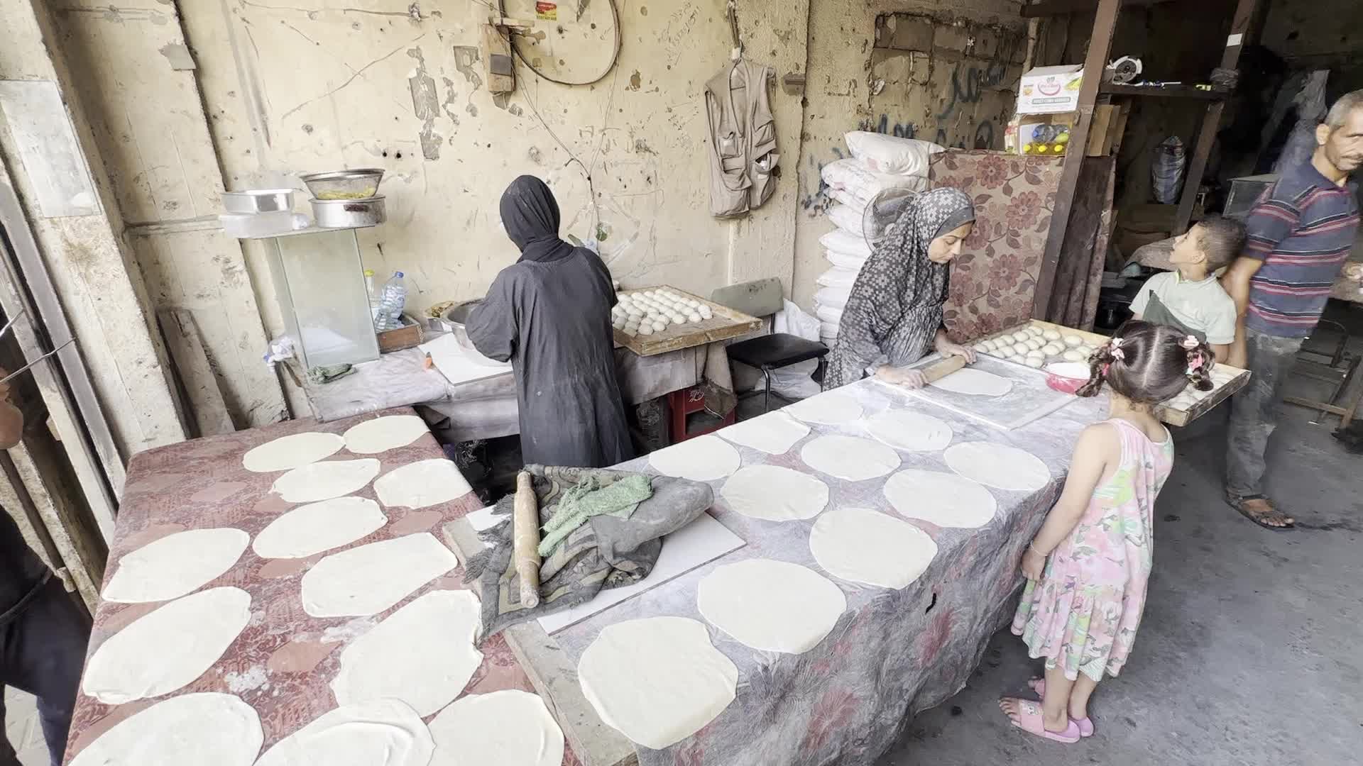 Displaced Palestinian Woman Prepares Flatbread Dough at Stall Kitchen in Central Gaza Strip Amid Ongoing Conflict