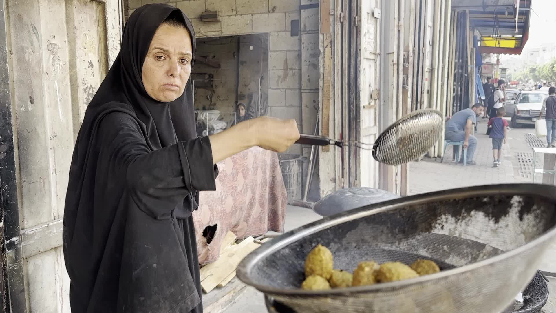 Displaced Palestinian Woman Prepares Flatbread Dough at Stall Kitchen in Central Gaza Strip Amid Ongoing Conflict