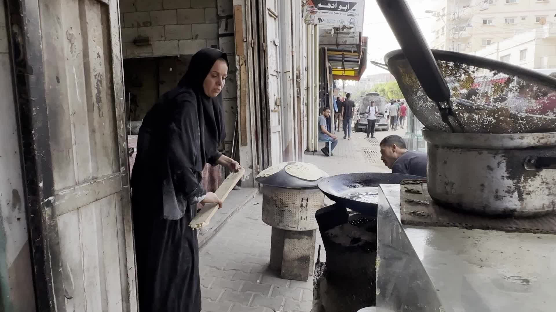 Displaced Palestinian Woman Prepares Flatbread Dough at Stall Kitchen in Central Gaza Strip Amid Ongoing Conflict
