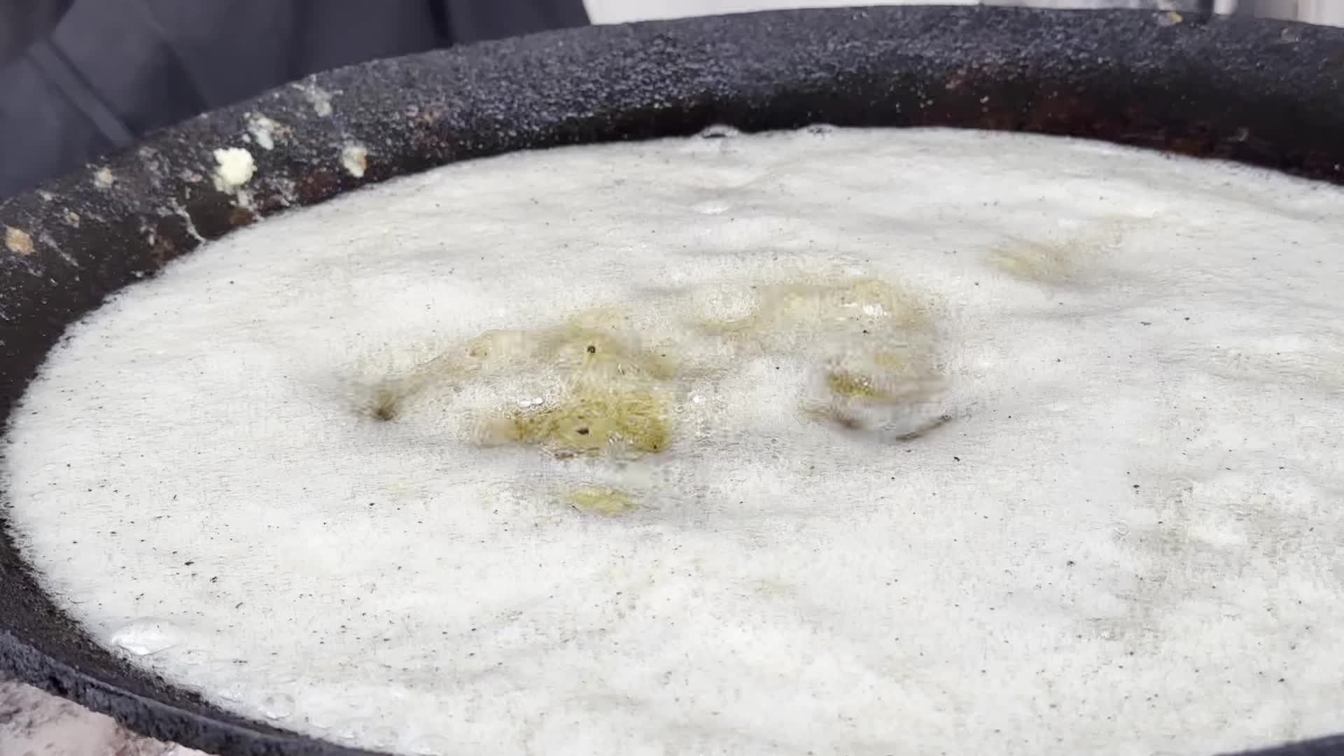 Displaced Palestinian Woman Prepares Flatbread Dough at Stall Kitchen in Central Gaza Strip Amid Ongoing Conflict