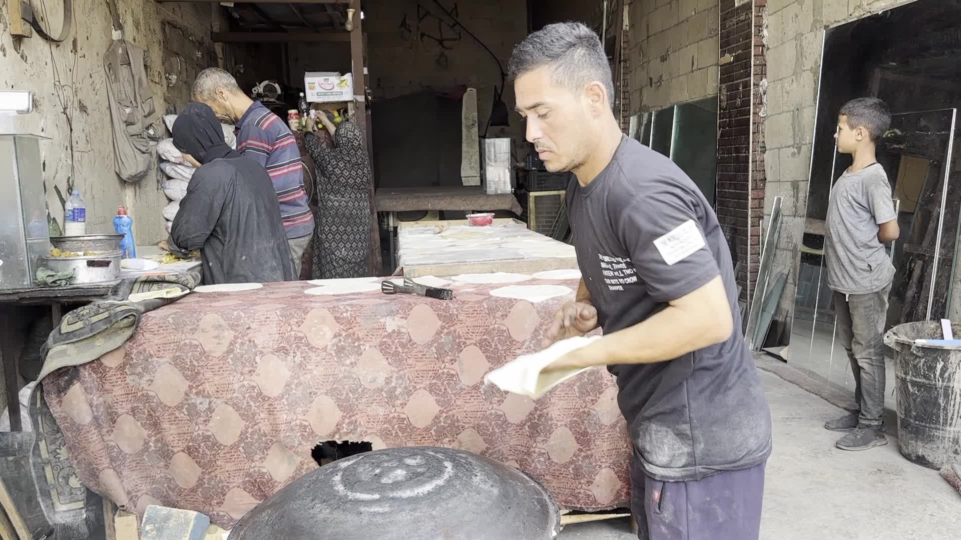 Displaced Palestinian Woman Prepares Flatbread Dough at Stall Kitchen in Central Gaza Strip Amid Ongoing Conflict