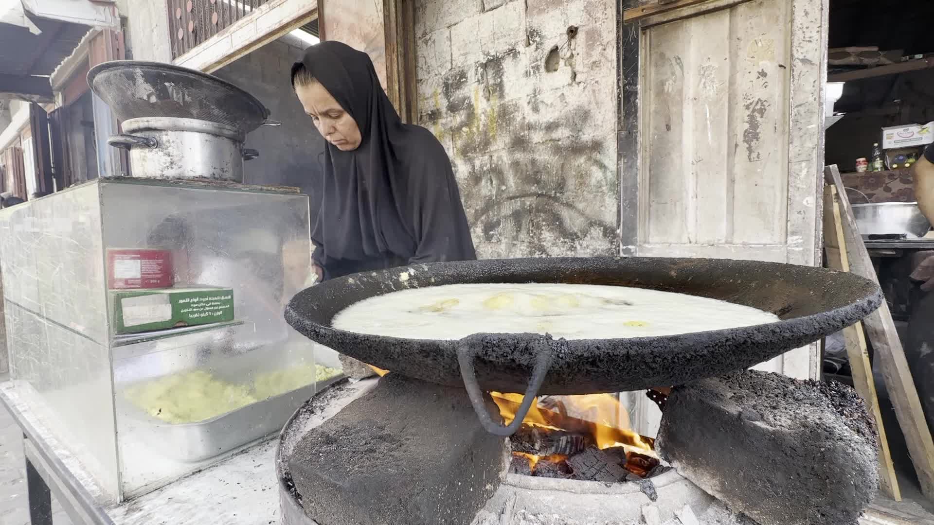 Displaced Palestinian Woman Prepares Flatbread Dough at Stall Kitchen in Central Gaza Strip Amid Ongoing Conflict