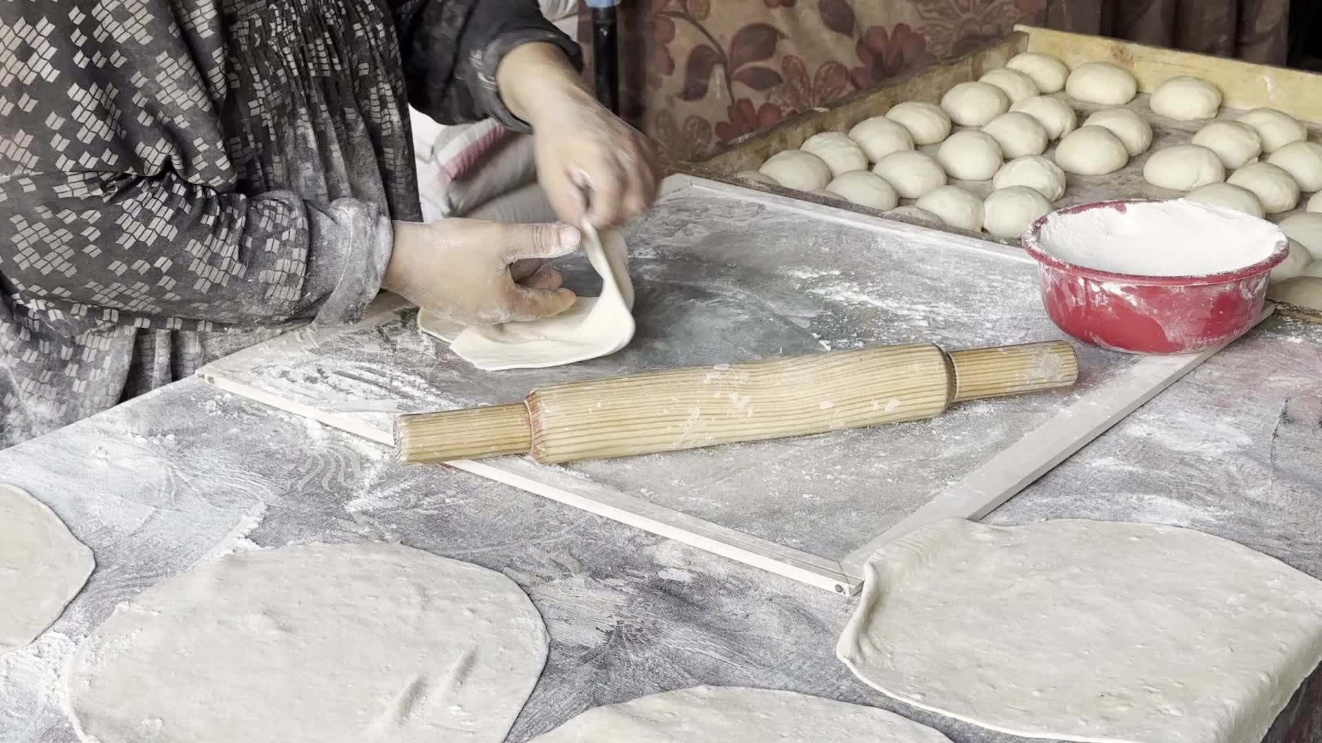 Displaced Palestinian Woman Prepares Flatbread Dough at Stall Kitchen in Central Gaza Strip Amid Ongoing Conflict