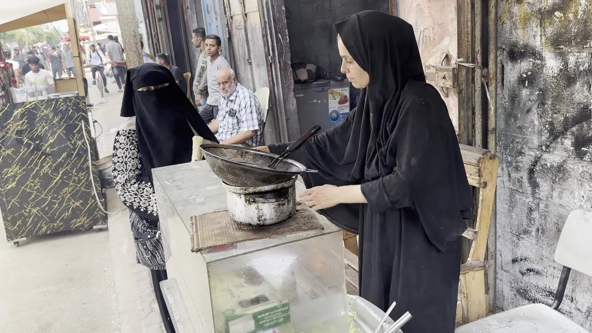 Displaced Palestinian Woman Prepares Flatbread Dough at Stall Kitchen in Central Gaza Strip Amid Ongoing Conflict