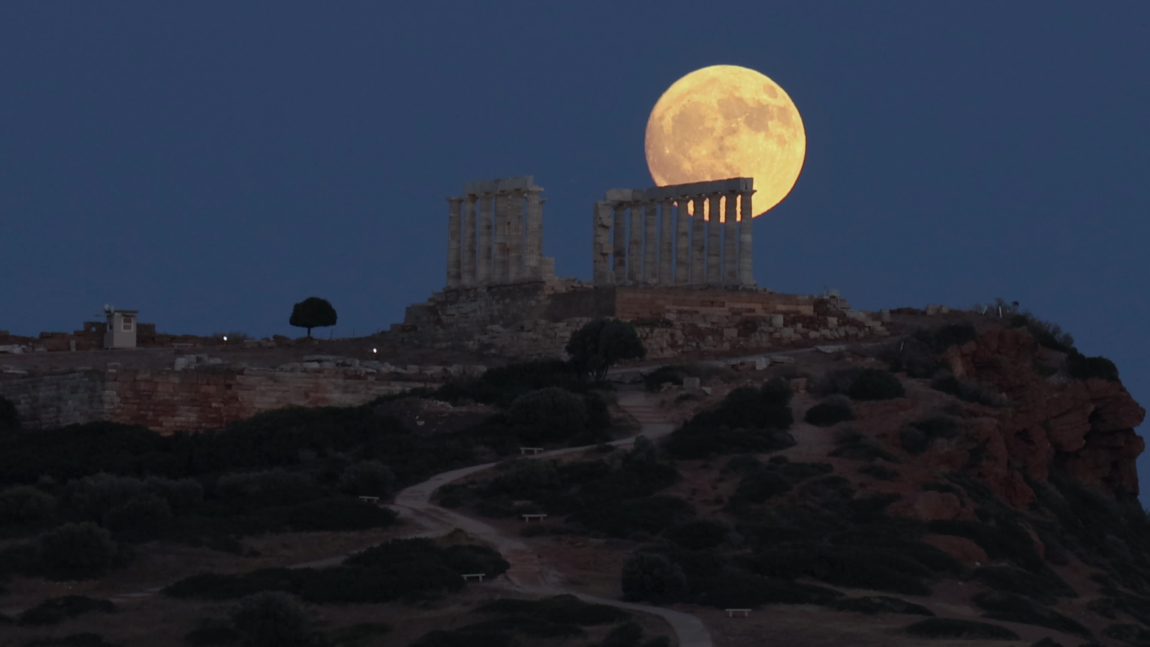 Full Moon Rising Behind Ancient Temple in Greece