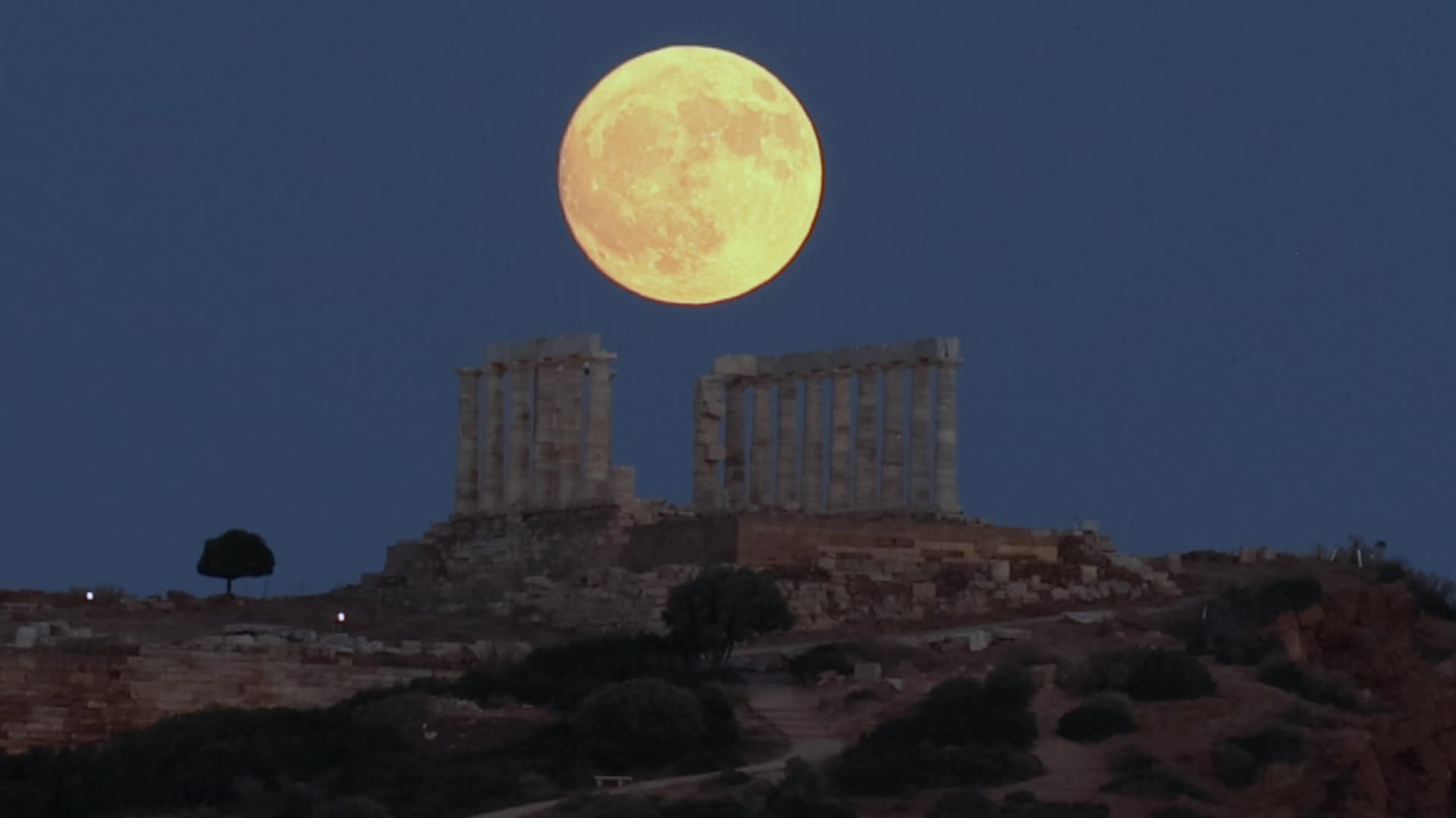 Full Moon Rising Behind Ancient Temple in Greece