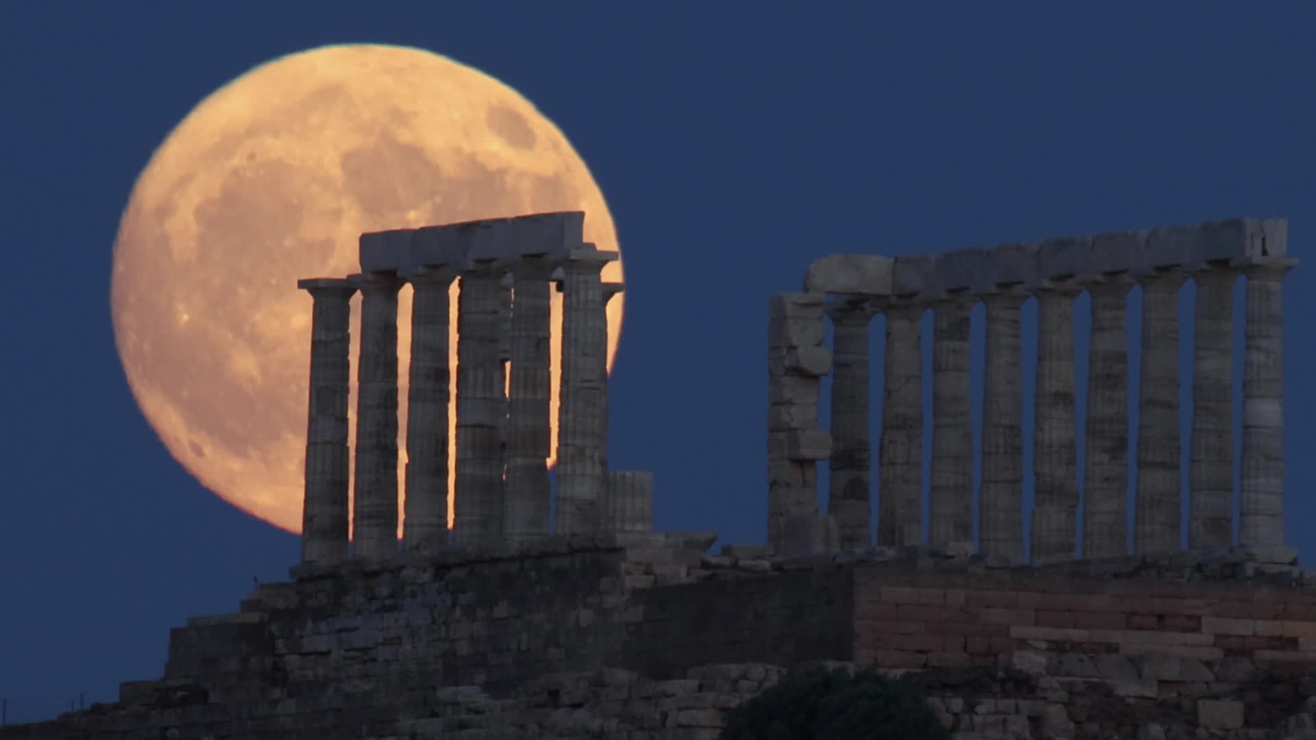 Full Moon Rising Behind Ancient Temple in Greece