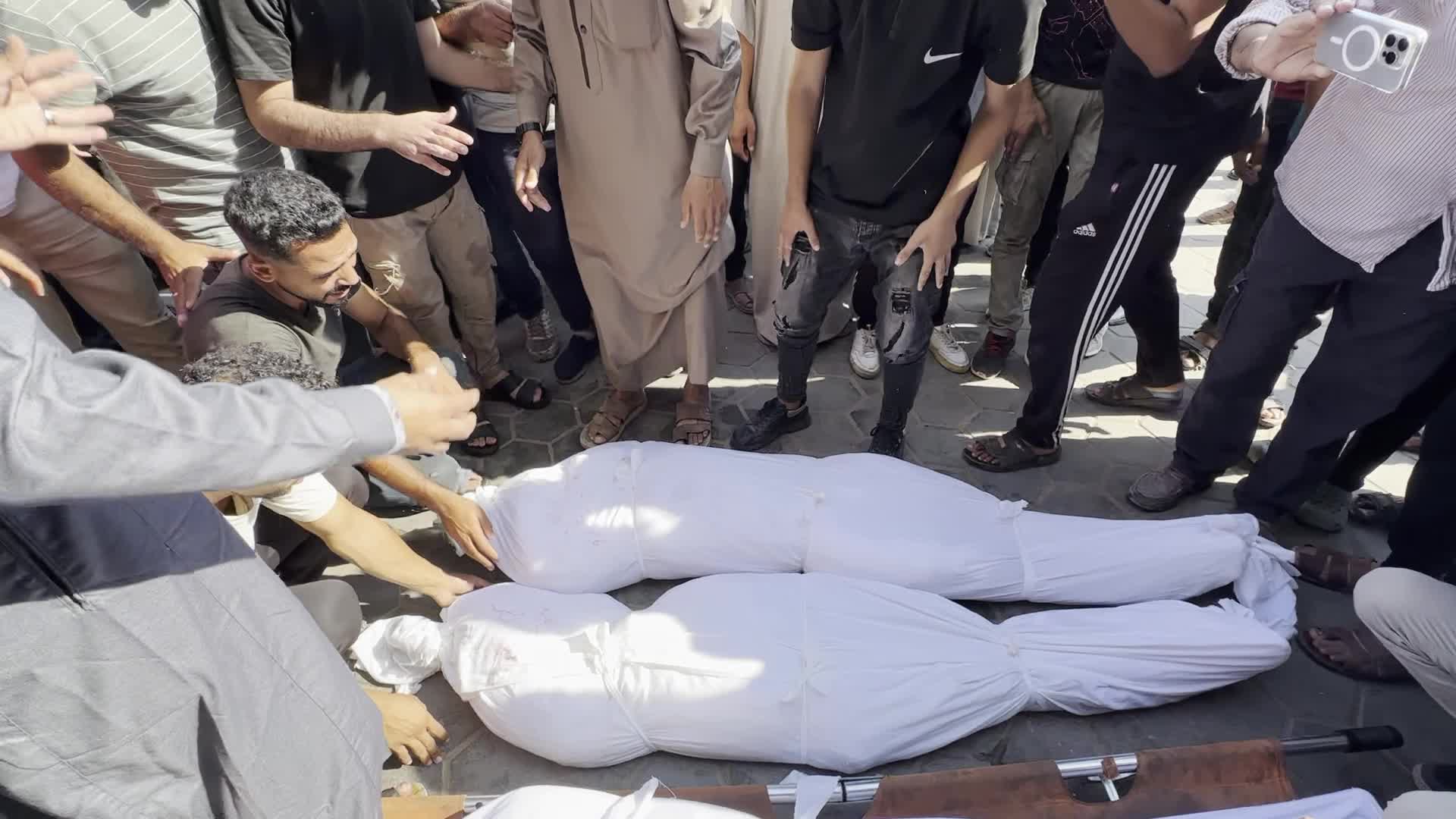 Palestinian Men Pray Over Victims of Israeli Strike at Aqsa Martyrs Hospital in Deir el-Balah