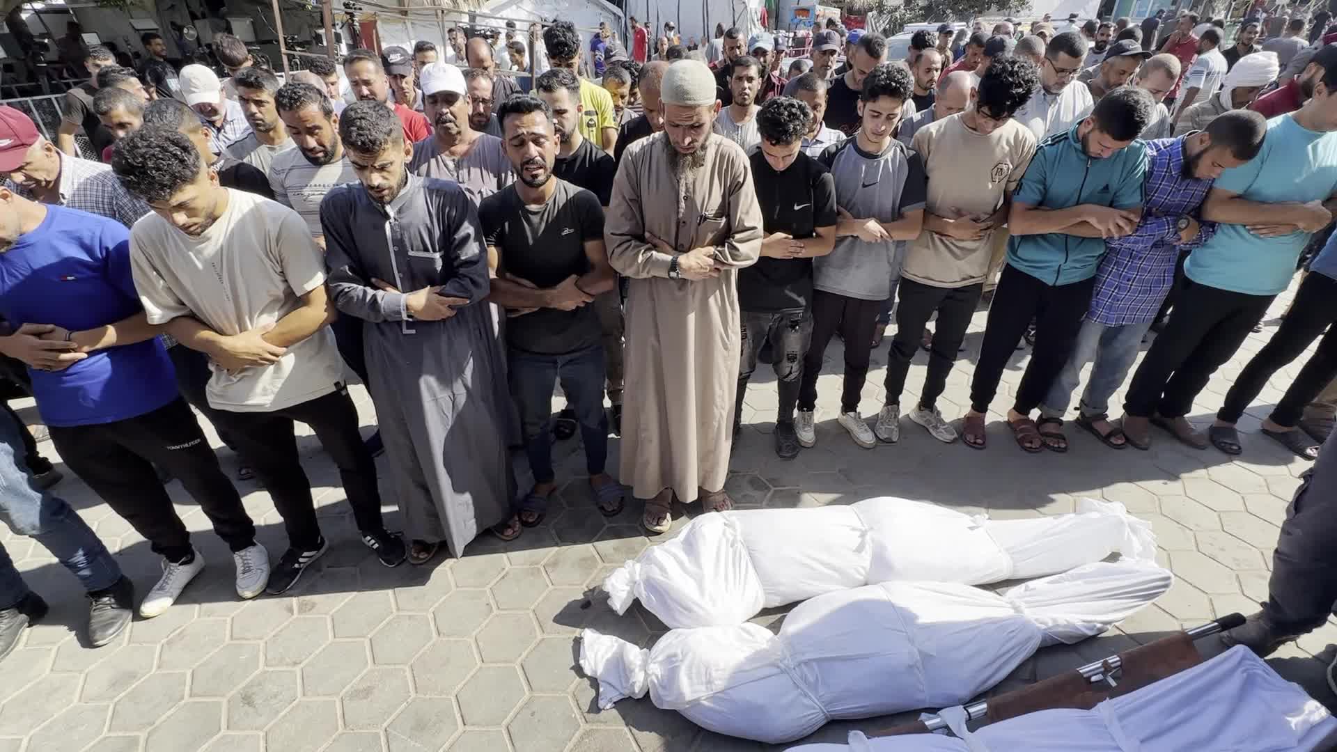 Palestinian Men Pray Over Victims of Israeli Strike at Aqsa Martyrs Hospital in Deir el-Balah