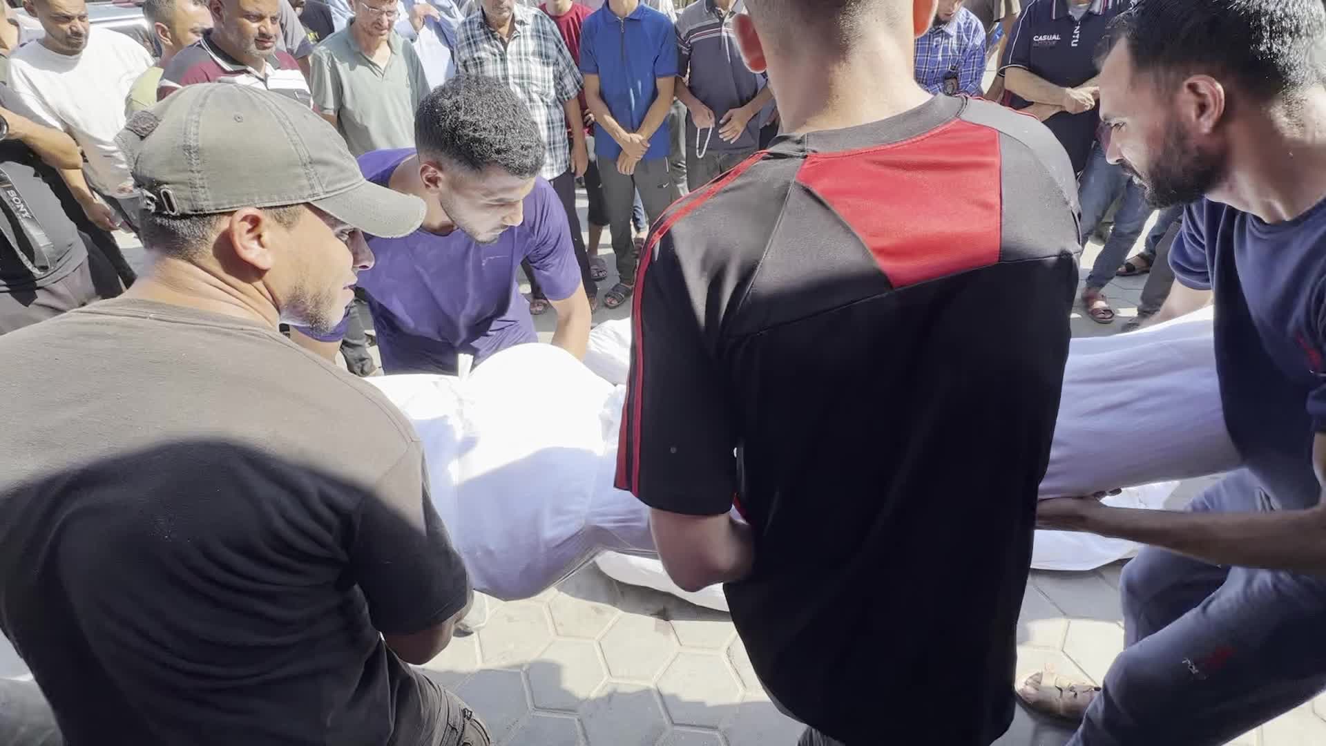 Palestinian Men Pray Over Victims of Israeli Strike at Aqsa Martyrs Hospital in Deir el-Balah