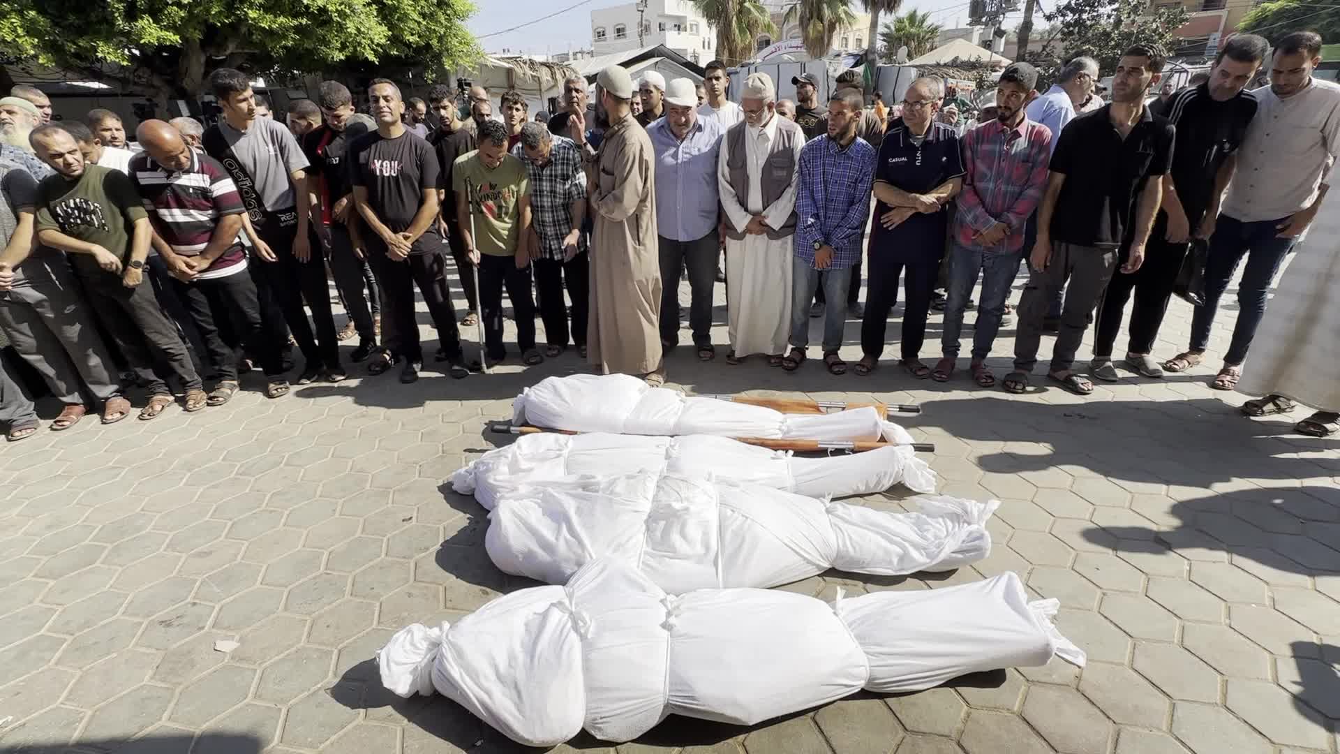Palestinian Men Pray Over Victims of Israeli Strike at Aqsa Martyrs Hospital in Deir el-Balah