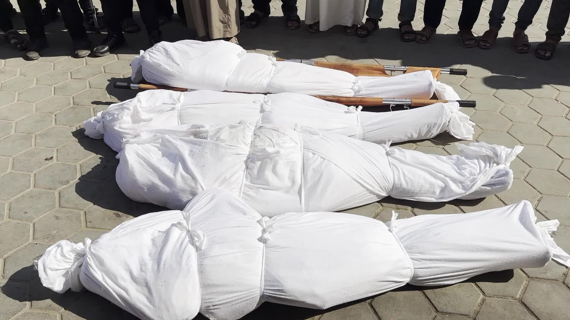 Palestinian Men Pray Over Victims of Israeli Strike at Aqsa Martyrs Hospital in Deir el-Balah