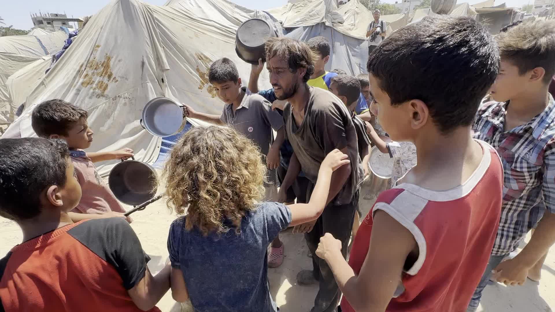 Displaced Palestinians Gather for Charity Food Distribution Amid Ongoing Israel-Hamas Conflict in Al-Zawaida, Central Gaza