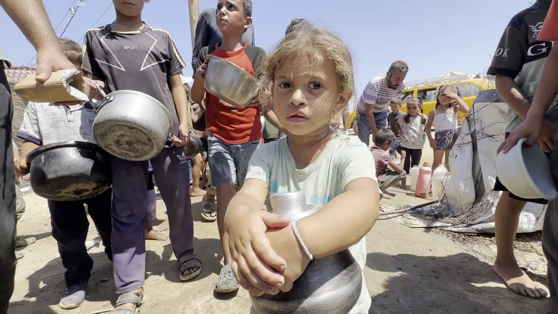 Displaced Palestinians Gather for Charity Food Distribution Amid Ongoing Israel-Hamas Conflict in Al-Zawaida, Central Gaza
