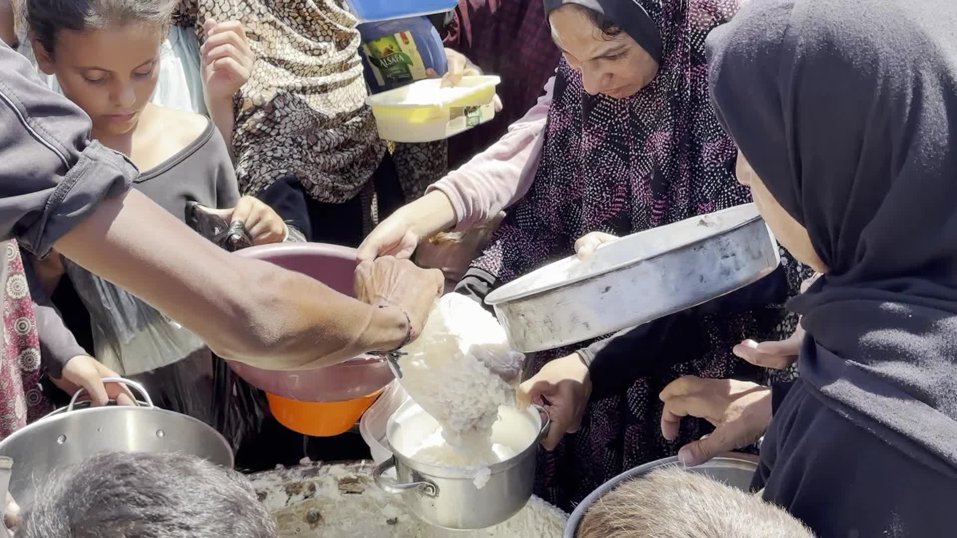Displaced Palestinians Gather for Charity Food Distribution Amid Ongoing Israel-Hamas Conflict in Al-Zawaida, Central Gaza