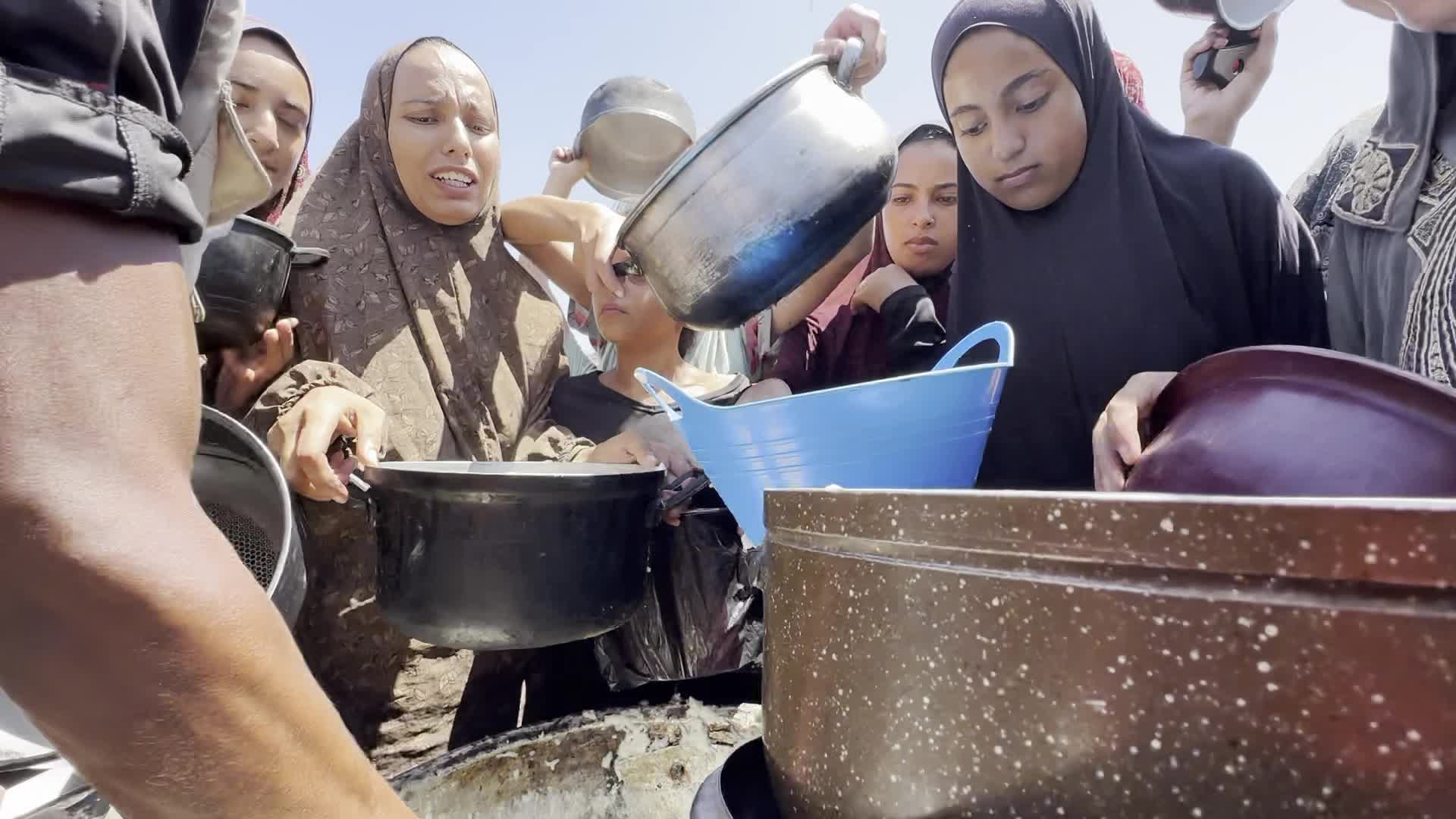 Displaced Palestinians Gather for Charity Food Distribution Amid Ongoing Israel-Hamas Conflict in Al-Zawaida, Central Gaza