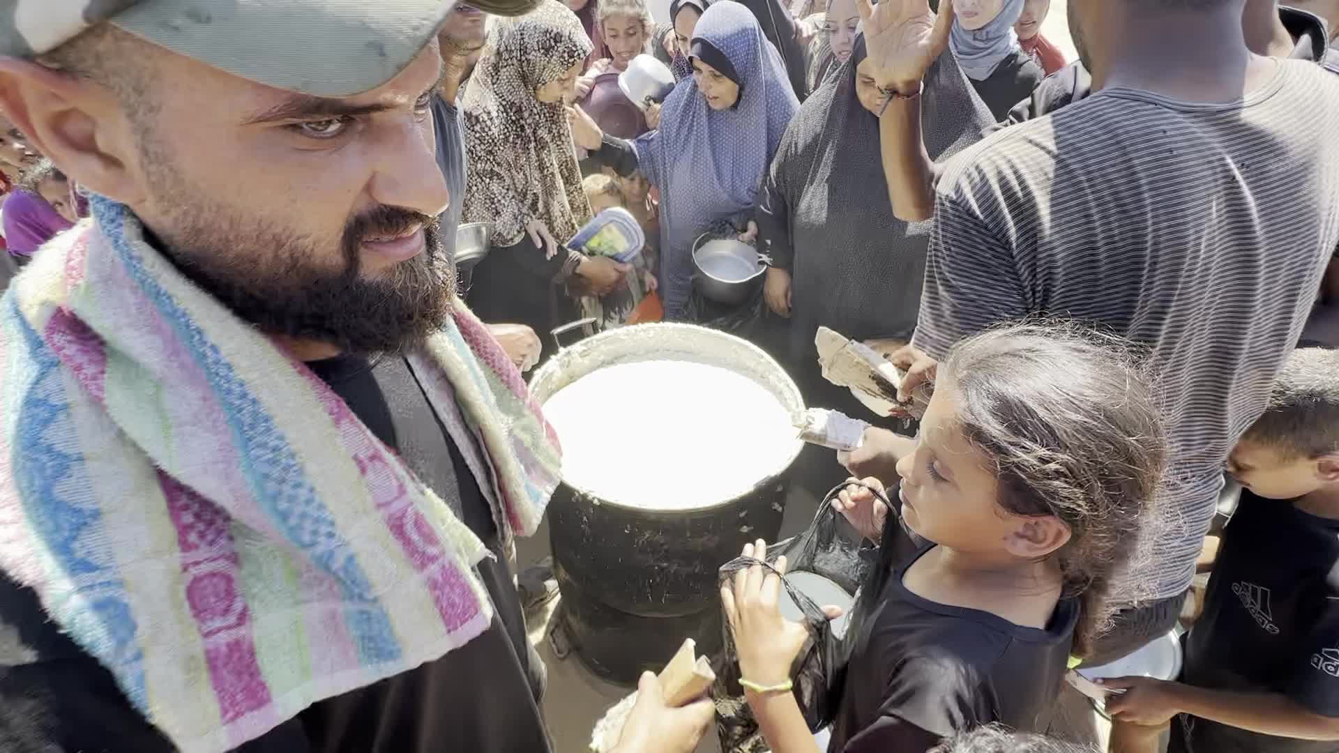 Displaced Palestinians Gather for Charity Food Distribution Amid Ongoing Israel-Hamas Conflict in Al-Zawaida, Central Gaza