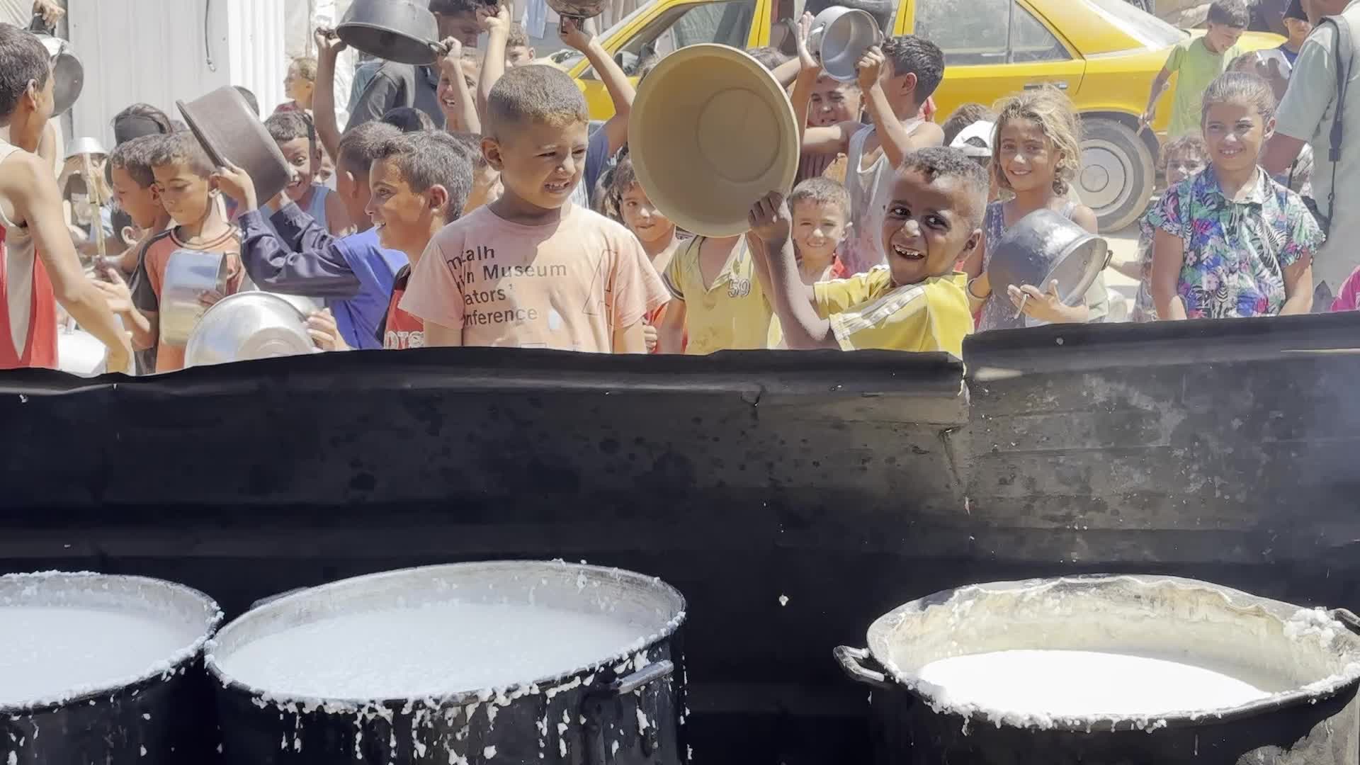Displaced Palestinians Gather for Charity Food Distribution Amid Ongoing Israel-Hamas Conflict in Al-Zawaida, Central Gaza