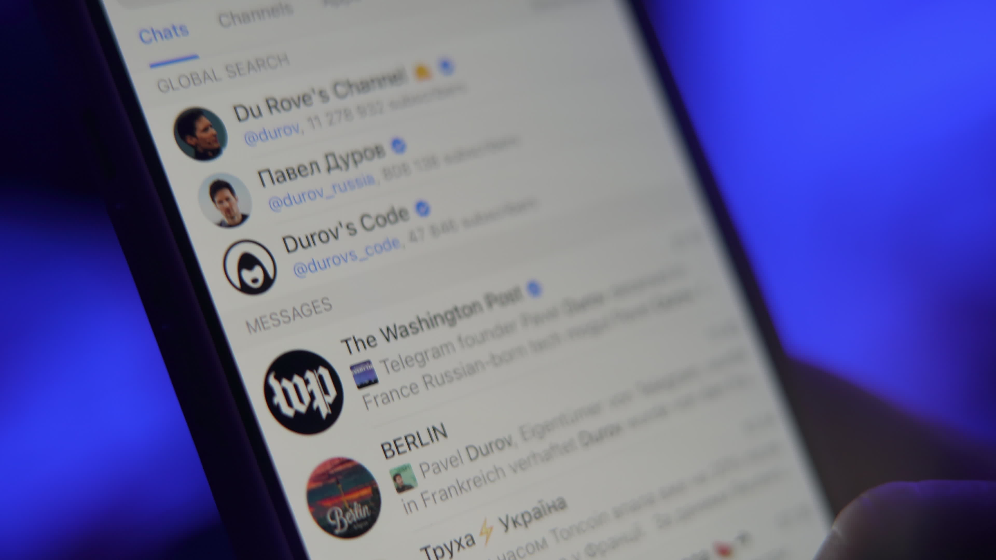 User with Telegram Messaging App on a Mobile Device