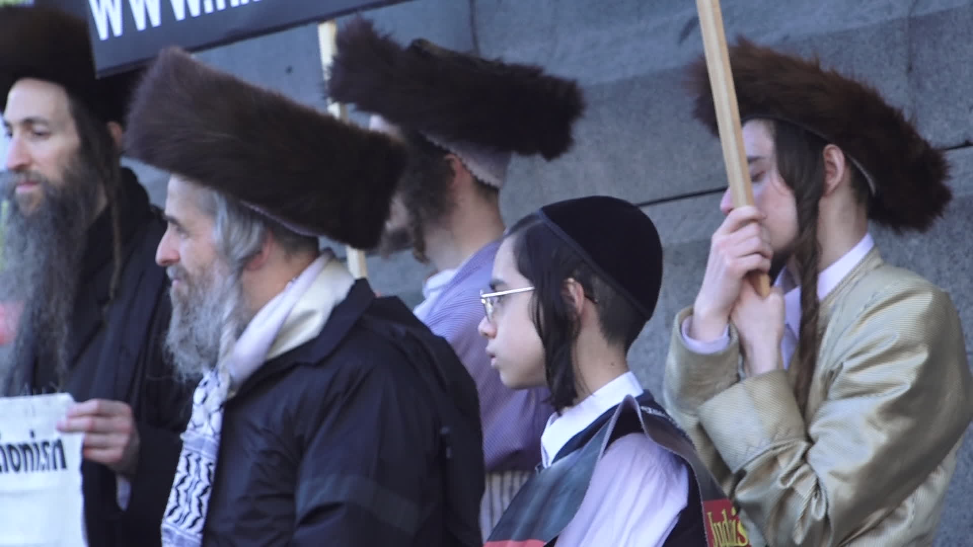 Protesters hold pro-Palestine placards during the demonstration in London
