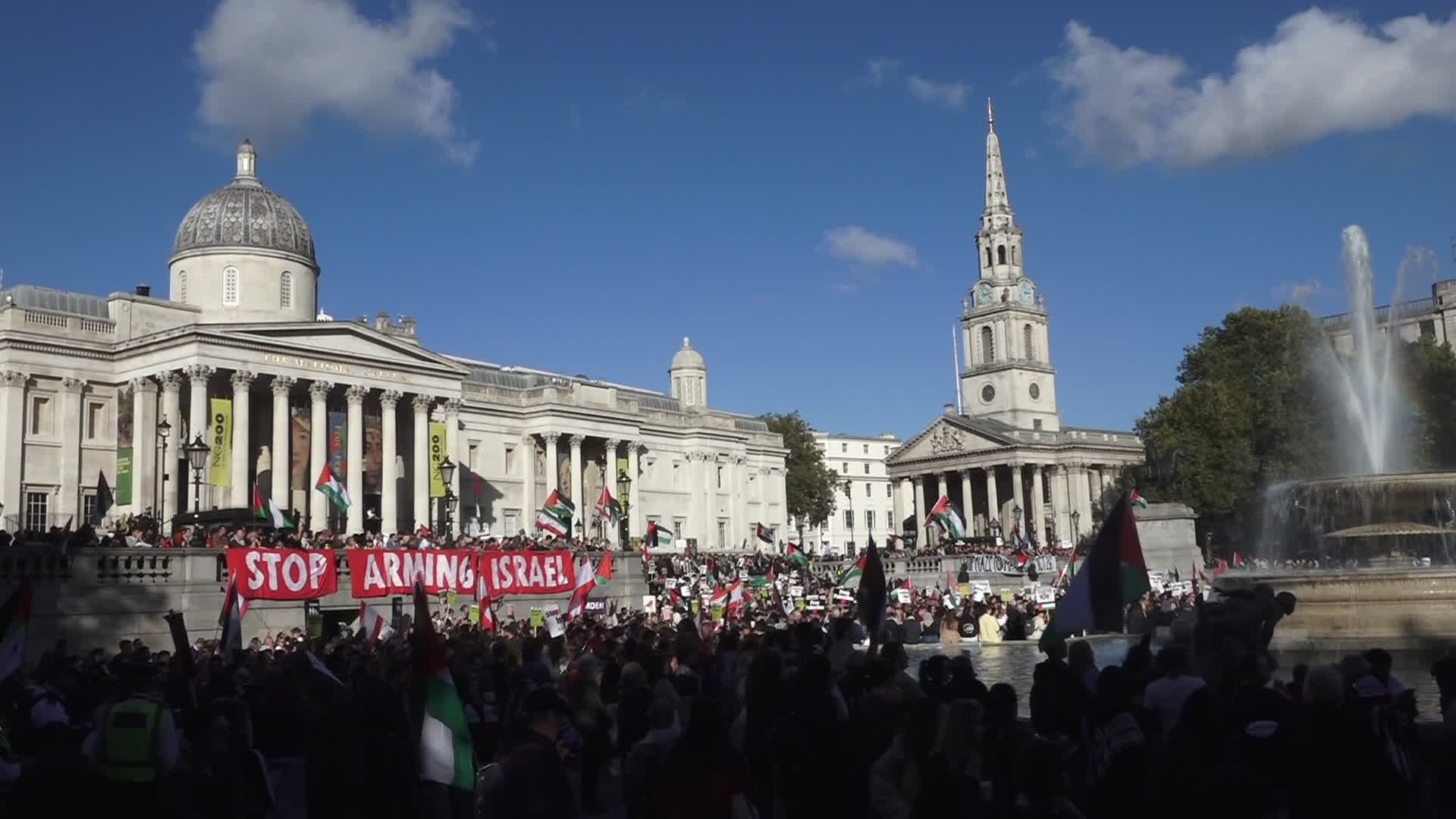 Protesters hold pro-Palestine placards during the demonstration in London