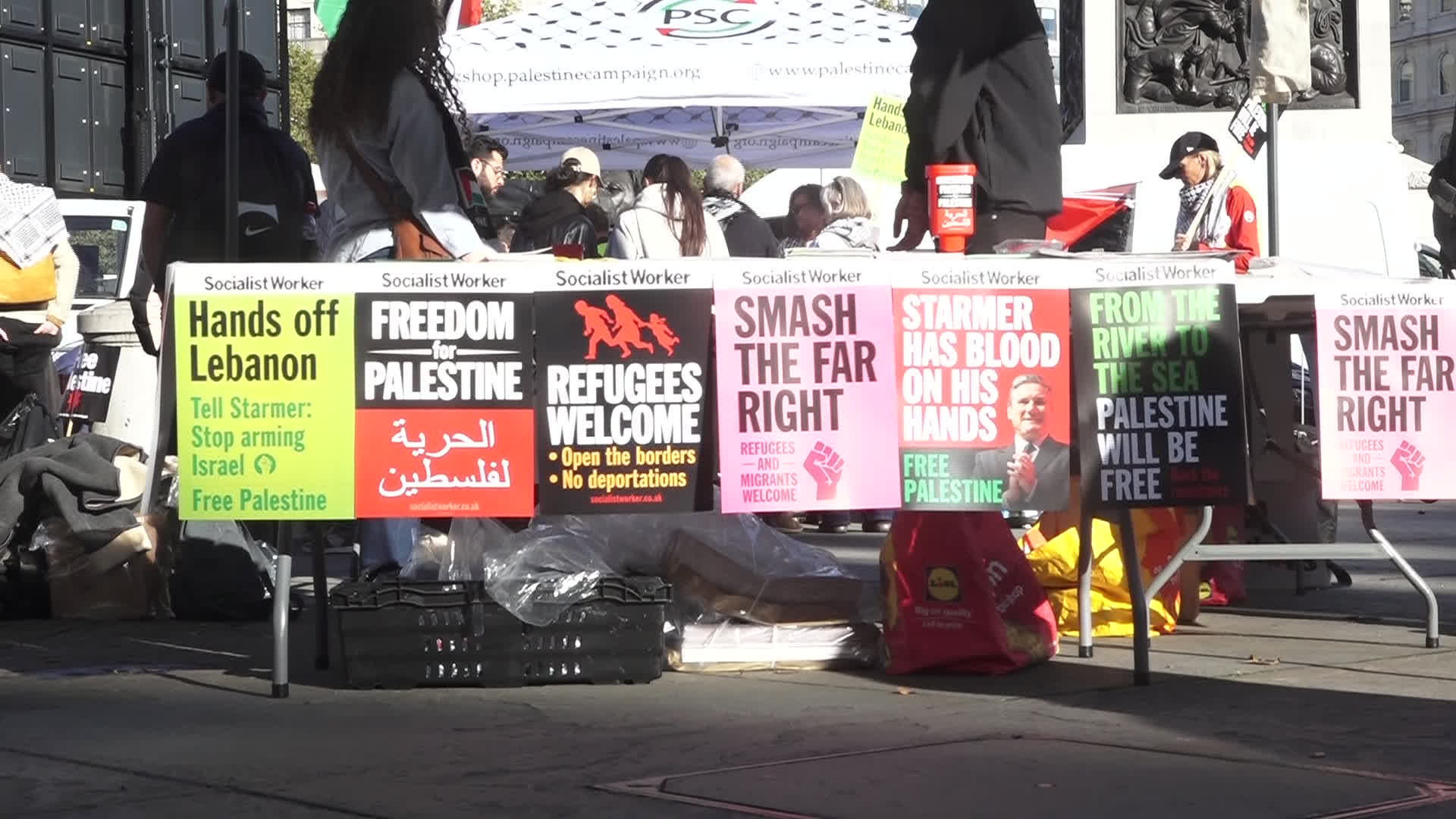 Protesters hold pro-Palestine placards during the demonstration in London