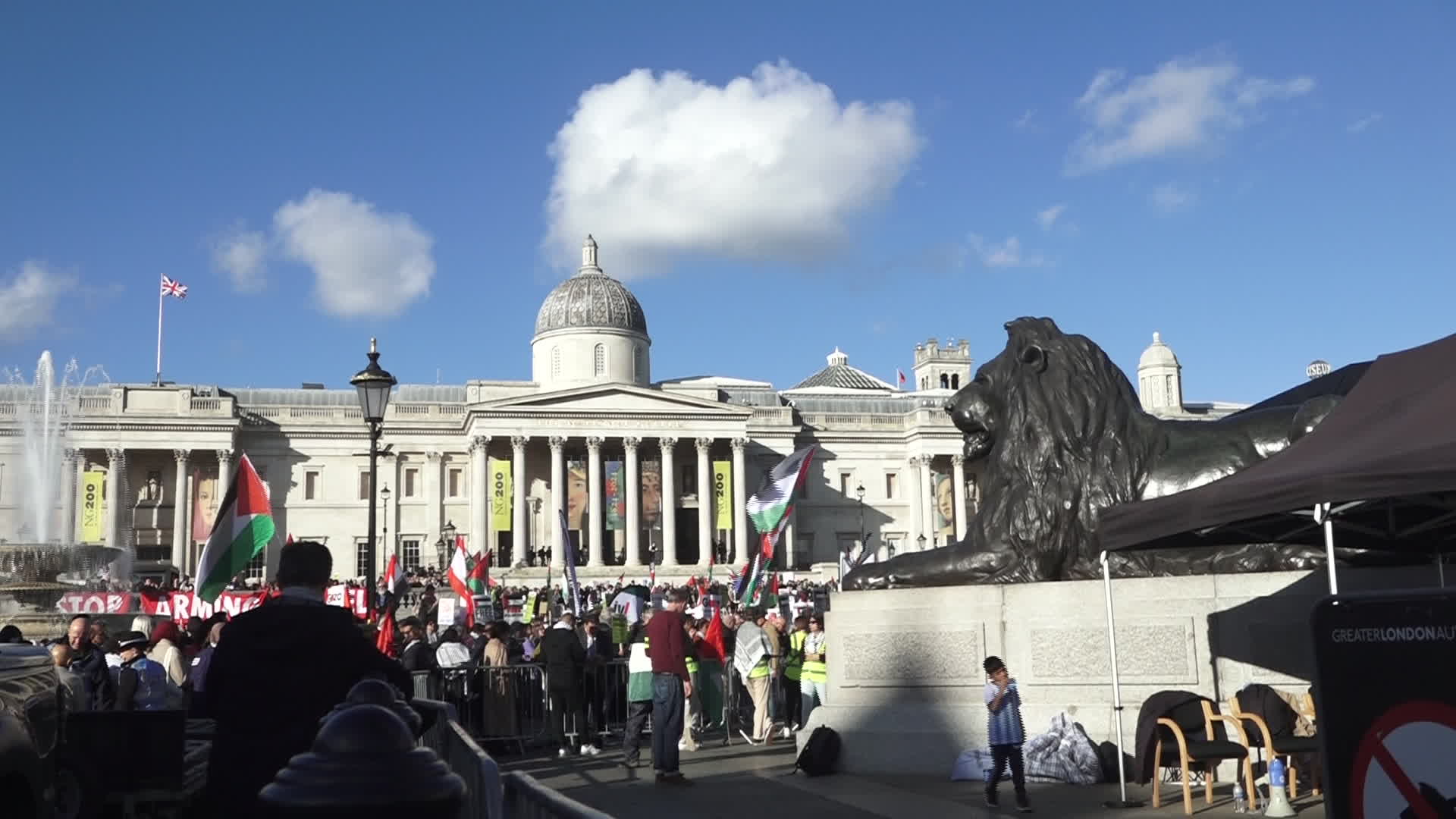 Protesters hold pro-Palestine placards during the demonstration in London