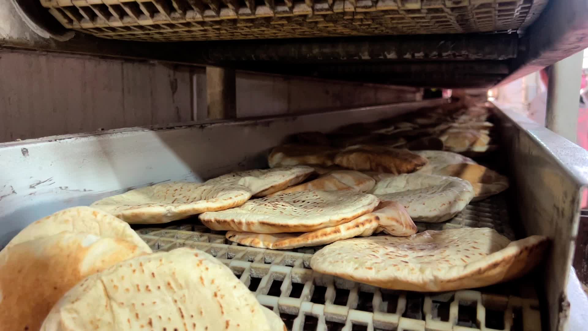 Palestinians Queue for Bread in Khan Yunis Amid Gaza Conflict